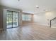 Spacious living room features tile flooring and sliding glass doors to the backyard at 30073 Southwell Ln, Wesley Chapel, FL 33543