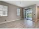 Bright living room featuring tile flooring, large windows, and sliding glass doors to the outdoor area at 30073 Southwell Ln, Wesley Chapel, FL 33543