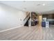 Open concept living space with stairs and view of modern kitchen at 30073 Southwell Ln, Wesley Chapel, FL 33543