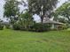 Expansive backyard features lush green lawn, mature trees, and privacy landscaping at 3110 57Th Avenue E Cir, Bradenton, FL 34203