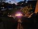 Backyard features a firepit and scenic views at twilight at 3110 57Th Avenue E Cir, Bradenton, FL 34203