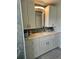 Renovated bathroom boasts shaker cabinets and drawers, plus updated vanity and mirror at 3110 57Th Avenue E Cir, Bradenton, FL 34203