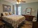 Bright bedroom with a comfortable queen-sized bed, coastal decor, and serene ambiance at 3110 57Th Avenue E Cir, Bradenton, FL 34203