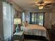 Bedroom features ceiling fan, coastal decor, and natural light from large windows at 3110 57Th Avenue E Cir, Bradenton, FL 34203
