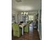 Dining room with modern table, chairs, wood floors, and an abundance of light at 3110 57Th Avenue E Cir, Bradenton, FL 34203