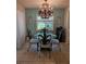 Dining room featuring a glass table, elegant chandelier, and bright natural light at 3110 57Th Avenue E Cir, Bradenton, FL 34203