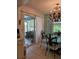 Dining room showcasing chandelier, glass table, and screened porch view at 3110 57Th Avenue E Cir, Bradenton, FL 34203