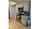 An updated kitchen featuring stainless steel appliances and sleek quartz countertops at 3110 57Th Avenue E Cir, Bradenton, FL 34203