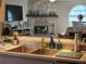 Kitchen area that offers stainless steel sink overlooking a cozy living area with stone fireplace at 3110 57Th Avenue E Cir, Bradenton, FL 34203