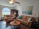 Cozy living room featuring leather furniture, vaulted ceiling, and ample natural light at 3110 57Th Avenue E Cir, Bradenton, FL 34203