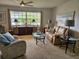 Bright living room featuring plush carpeting, a large window, and cozy furnishings at 3110 57Th Avenue E Cir, Bradenton, FL 34203