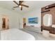 Bright bedroom featuring a ceiling fan, a large screen TV, and a make up vanity at 3129 61St E Ter, Ellenton, FL 34222
