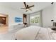 Well-lit bedroom featuring a ceiling fan, a large screen TV, and a large window at 3129 61St E Ter, Ellenton, FL 34222