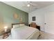 Bedroom featuring a modern ceiling fan, side table, and a clean white door at 3129 61St E Ter, Ellenton, FL 34222