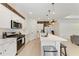 Contemporary kitchen with white cabinets, stainless steel appliances, and an island with bar seating, a chef's dream at 3129 61St E Ter, Ellenton, FL 34222