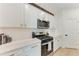 Well-lit kitchen with white cabinets, stainless steel appliances, and light countertops at 3129 61St E Ter, Ellenton, FL 34222