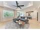 Inviting living room with a plush sofa, contemporary decor, and a view of the kitchen, ideal for relaxation at 3129 61St E Ter, Ellenton, FL 34222