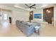 Bright living room with an open layout, a cozy gray sofa, a TV, and sleek modern decor, great for entertaining at 3129 61St E Ter, Ellenton, FL 34222