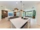 Open-concept living space with modern light fixtures and stainless steel appliances at 3129 61St E Ter, Ellenton, FL 34222