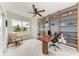 Bright office boasts custom built-ins, modern desk and chair, and lots of natural light from the large picture window at 3129 61St E Ter, Ellenton, FL 34222
