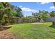 Fenced backyard with a grassy lawn, a small shed, and mature landscaping at 3320 19Th Street E Ct, Bradenton, FL 34208