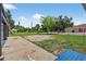 View from two-car detached garage across large backyard and the street beyond at 3320 19Th Street E Ct, Bradenton, FL 34208
