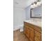 Bathroom vanity with wood cabinets, granite countertop, and decorative mirror at 3320 19Th Street E Ct, Bradenton, FL 34208
