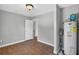 Bedroom features wood-look flooring and neutral paint, with an adjacent utility closet housing a water heater at 3320 19Th Street E Ct, Bradenton, FL 34208