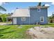Two-story home with blue siding, a metal roof, and a manicured lawn at 3320 19Th Street E Ct, Bradenton, FL 34208