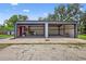 Two car garage with gray metal construction and concrete floor open at 3320 19Th Street E Ct, Bradenton, FL 34208