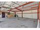 Spacious garage interior with painted walls, open ceiling, and concrete floor at 3320 19Th Street E Ct, Bradenton, FL 34208
