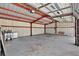 Spacious garage interior with painted walls, open ceiling, and concrete floor at 3320 19Th Street E Ct, Bradenton, FL 34208