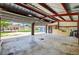 Spacious garage interior with painted walls, open ceiling, and concrete floor, doors open at 3320 19Th Street E Ct, Bradenton, FL 34208