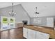 Open living area with vaulted ceilings, a fireplace, and seamless transition to the kitchen at 3320 19Th Street E Ct, Bradenton, FL 34208