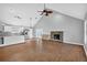 Inviting living room featuring a cozy fireplace, access to the patio, and seamless flow into the kitchen at 3320 19Th Street E Ct, Bradenton, FL 34208