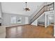 Spacious living area with wood-look tile flooring, vaulted ceilings, and staircase to the second floor at 3320 19Th Street E Ct, Bradenton, FL 34208