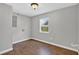 Empty, light gray room with wood-look floors and a bright window at 3320 19Th Street E Ct, Bradenton, FL 34208
