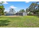 Large lot with a blue house and spacious yard, complete with a two-car detached garage at 3320 19Th Street E Ct, Bradenton, FL 34208