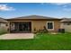 Backyard with covered patio, lush lawn, and privacy fence at 3712 76Th E St, Palmetto, FL 34221