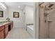 Bathroom with a tiled shower, soaking tub, granite vanity and neutral-toned tile flooring at 3712 76Th E St, Palmetto, FL 34221