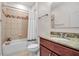 Bathroom features a tub with shower, granite vanity and neutral-toned tile flooring at 3712 76Th E St, Palmetto, FL 34221