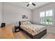 Bedroom with ceiling fan, shuttered window and wood floors at 3712 76Th E St, Palmetto, FL 34221