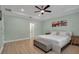 Relaxing bedroom featuring a tray ceiling, ceiling fan, light green walls, and bright light at 3712 76Th E St, Palmetto, FL 34221