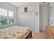 Bedroom with ceiling fan, closet, shuttered window and wood floors at 3712 76Th E St, Palmetto, FL 34221