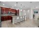 Bright kitchen with a granite island, stainless steel appliances, tile backsplash, and breakfast bar seating at 3712 76Th E St, Palmetto, FL 34221