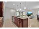 Open kitchen with granite island, stainless appliances, and views of the living and dining areas at 3712 76Th E St, Palmetto, FL 34221