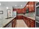 Gourmet kitchen features stainless steel appliances, granite countertops, tiled backsplash, and tile flooring at 3712 76Th E St, Palmetto, FL 34221