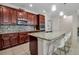 Bright kitchen with a granite island, stainless steel appliances, tile backsplash, and breakfast bar seating at 3712 76Th E St, Palmetto, FL 34221
