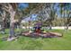 A charming neighborhood playground invites children to play with slides and other equipment in a shaded, green space at 3712 76Th E St, Palmetto, FL 34221