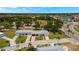 Expansive aerial view of the house, showcasing its location, mature trees and proximity to the golf course at 386 Club Manor Dr, Sun City Center, FL 33573